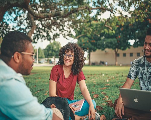 Group of friends laughing enjoying a healthy social outdoor lifestyle